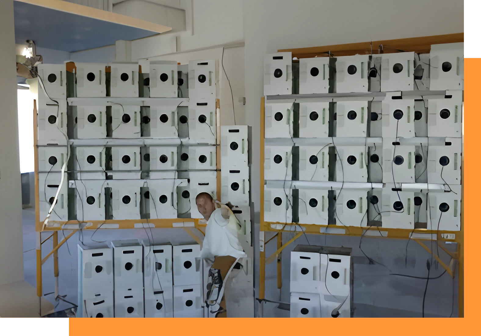 A man standing in front of many boxes.