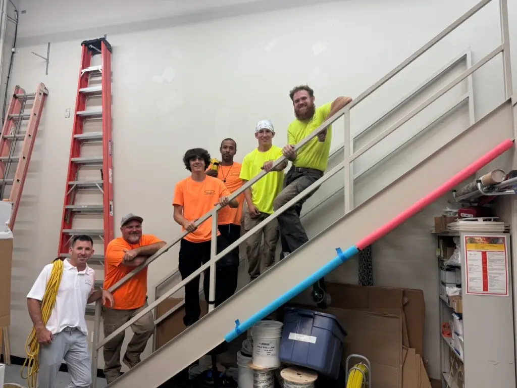 A group of men standing on top of stairs.