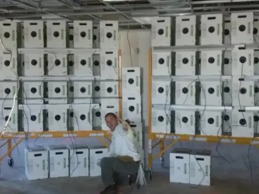 A man sitting in front of many boxes.