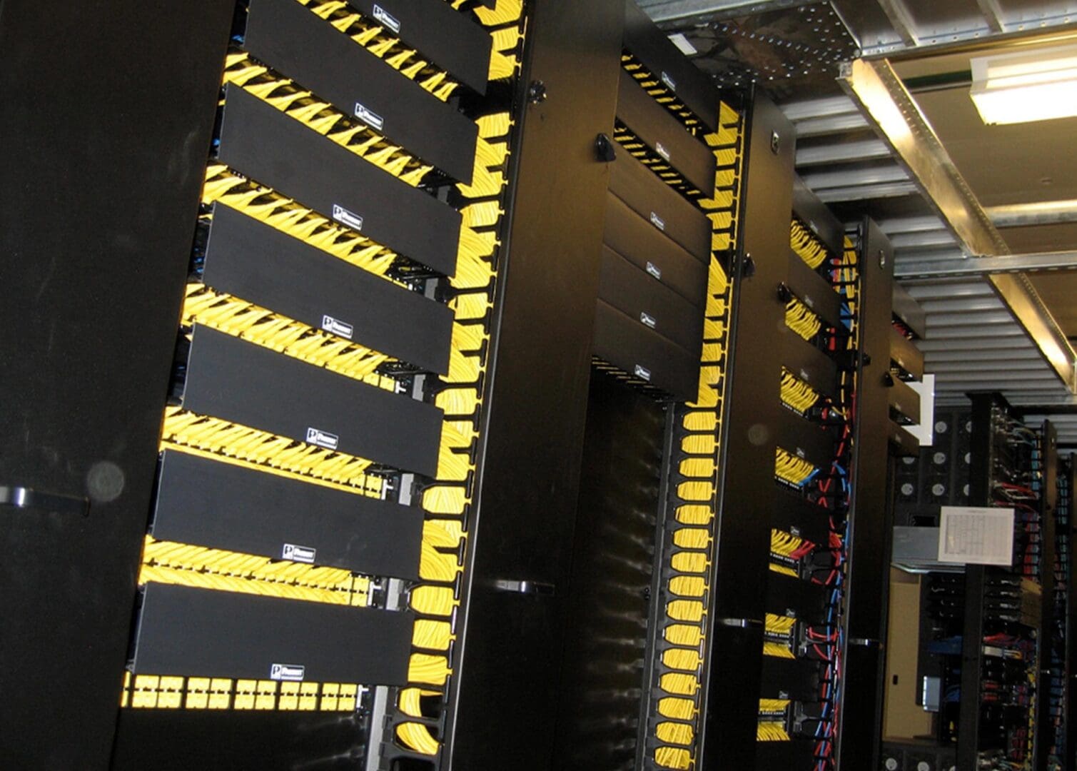 A large black and yellow wall of computers.