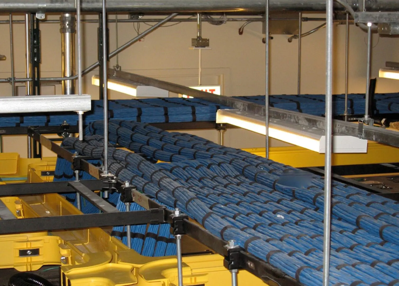 A large amount of blue and yellow seats in an assembly line.