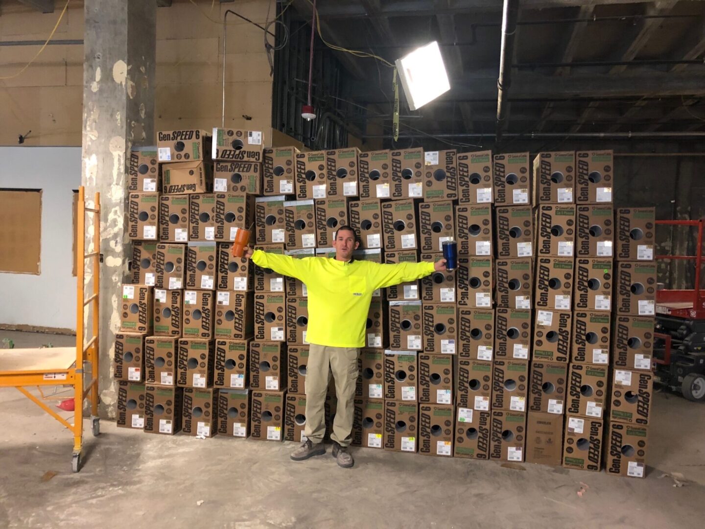 A man standing in front of stacks of boxes.