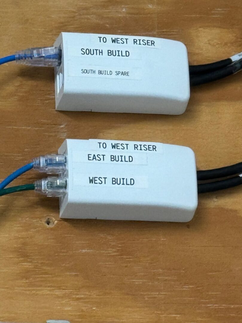 Two electrical wires connected to a white device.